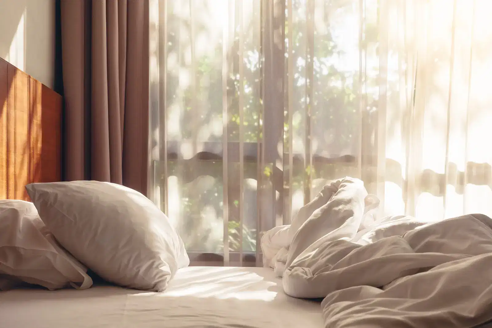Soft morning light on an unmade bed, a quiet picture of rest after ADHD burnout