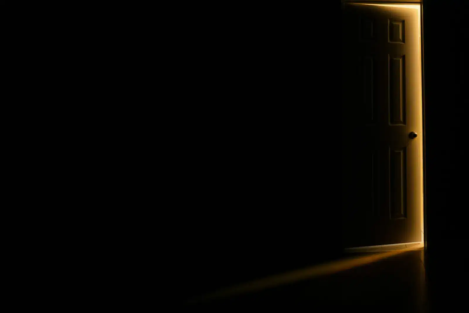 Warm light from a door left slightly open, like the first step out of ADHD paralysis