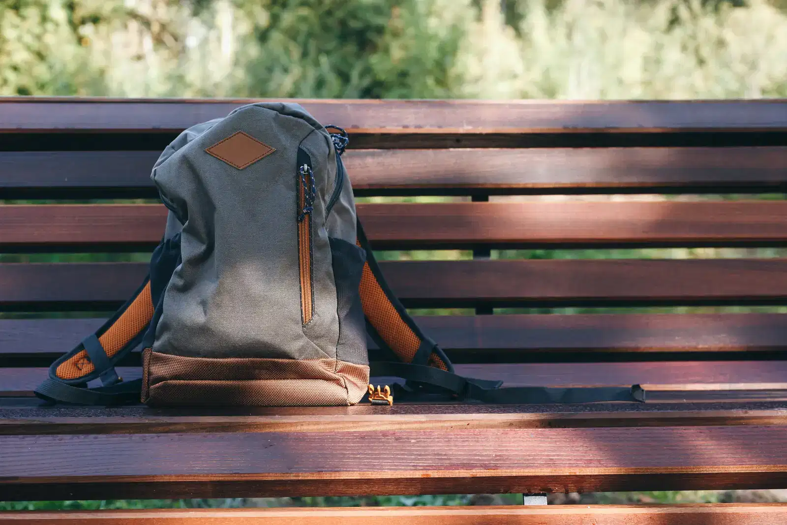 A backpack set down on a park bench, like putting down the weight of spouse burnout