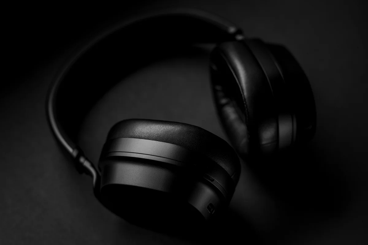 A pair of headphones resting in low light, for privacy during a session