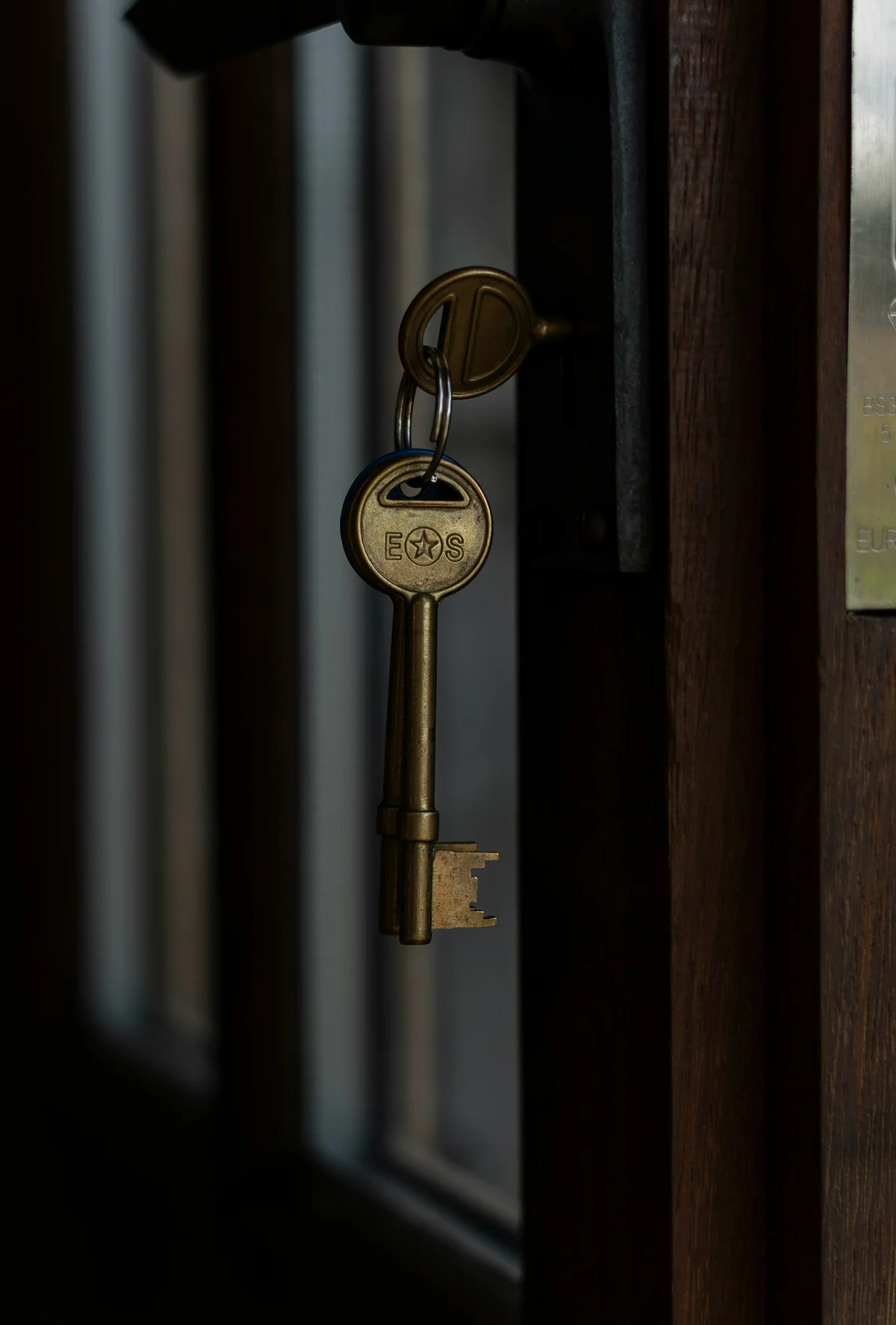 A key turned in a dark door, an image of the checking that comes with OCD and intrusive thoughts