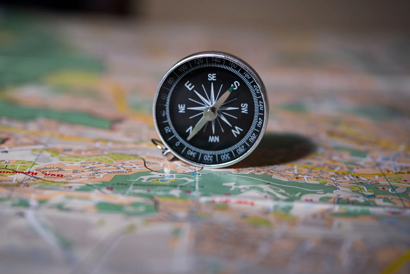 A compass standing on an open map in warm light, an image for pre-marital counselling conversations