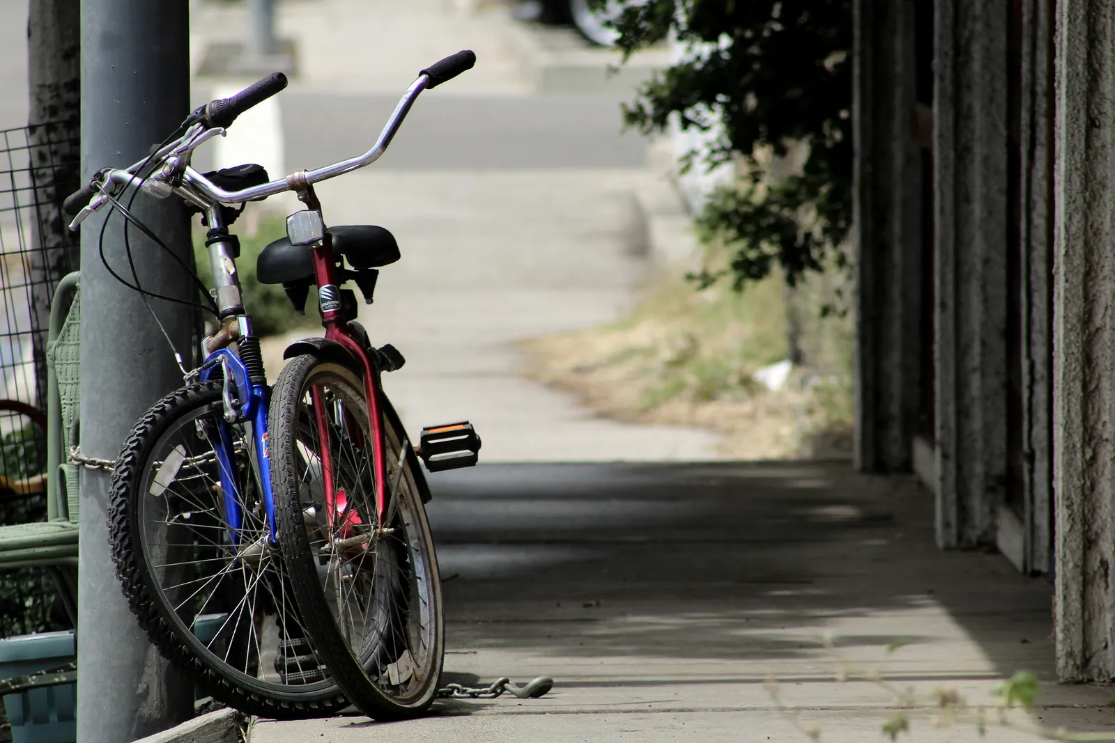 Two bicycles leaning against each other on a quiet sidewalk, an image for relationship counselling